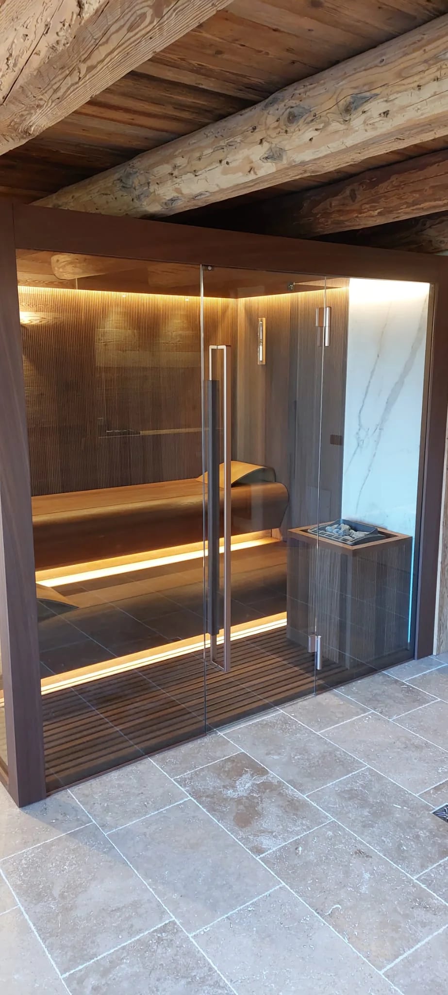 Full-height glass door on an installed INFINITY Sauna