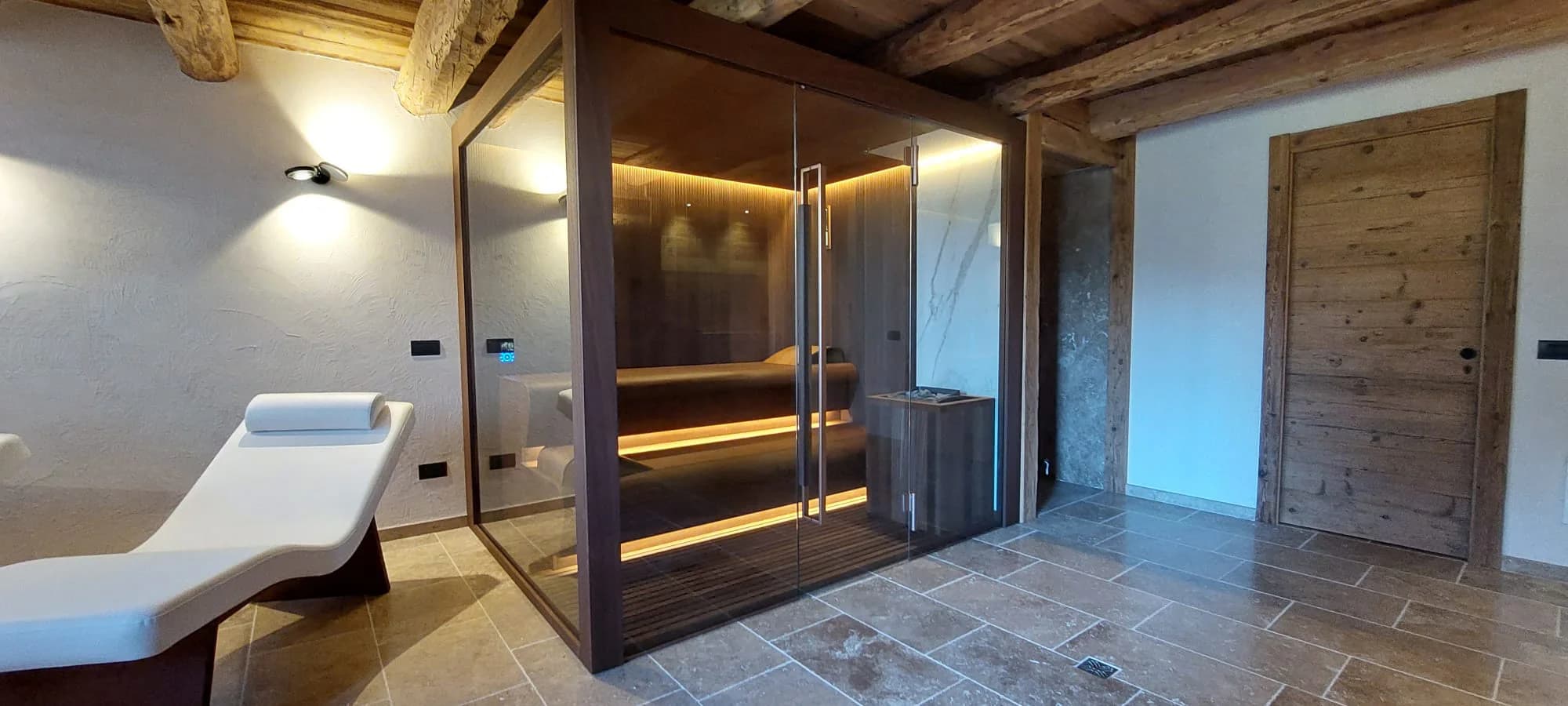 INFINITY Sauna installed beside a relaxation lounger in a private wellness room