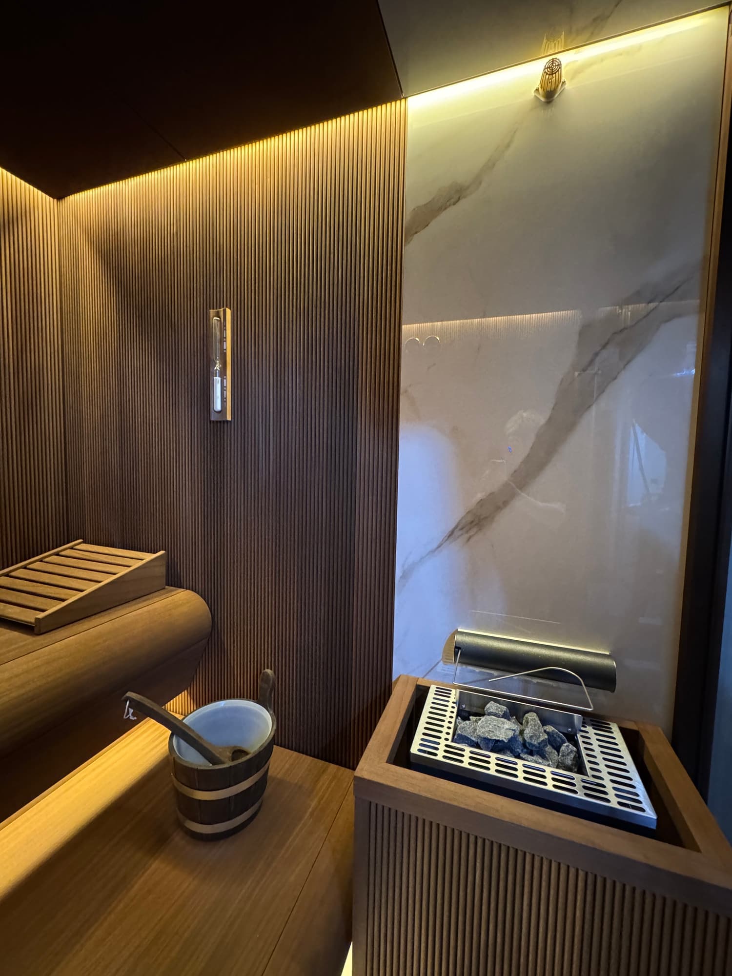 Completed Dartmouth Sauna heater, timber guard and illuminated interior