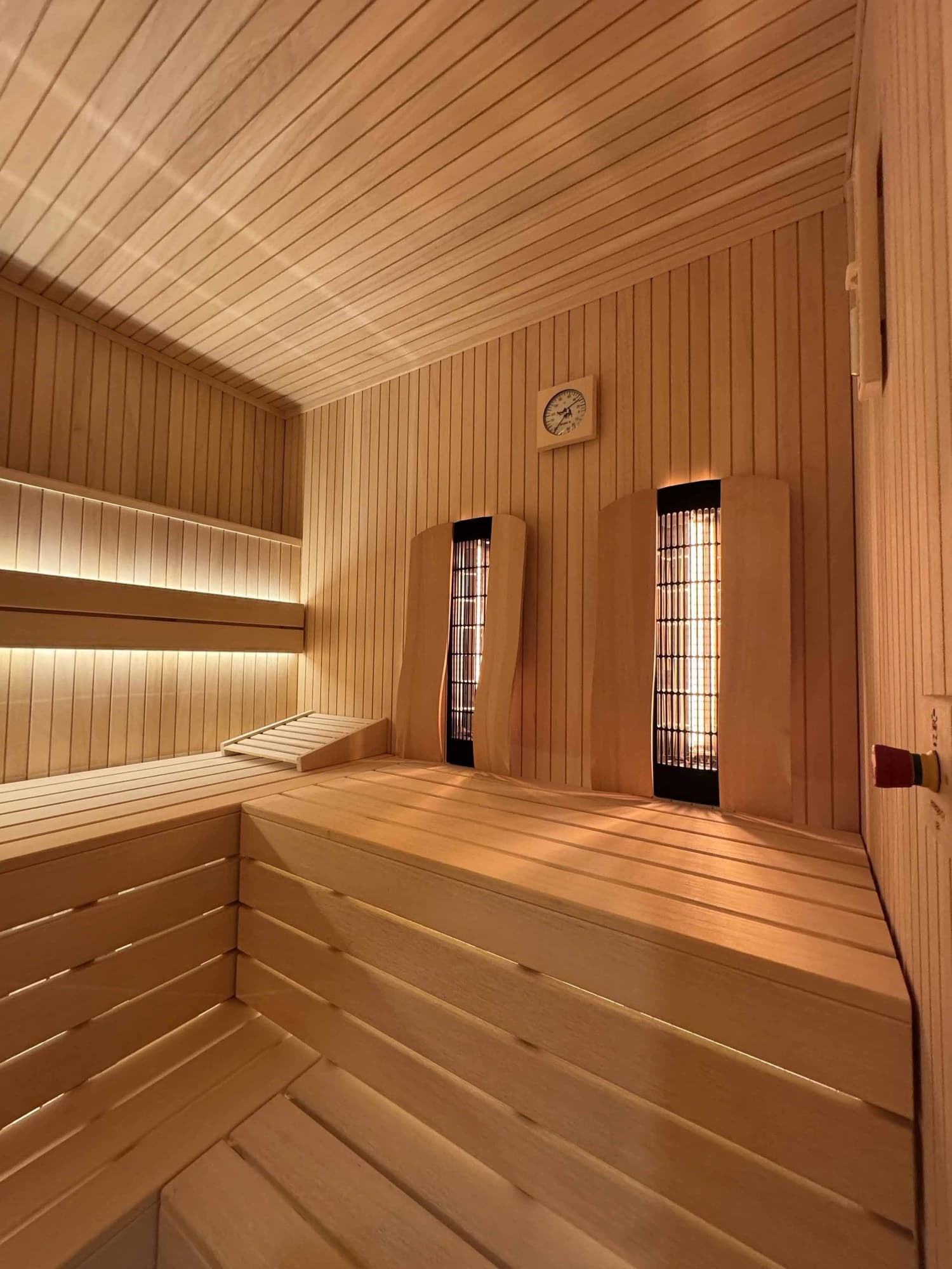 Sauna interior lit with warm perimeter lighting