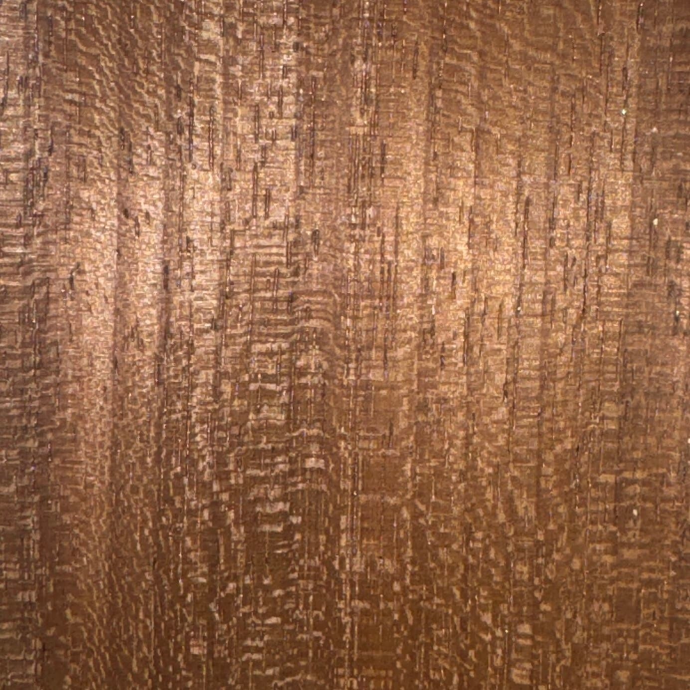 Close-up of a wood grain texture on a brown wooden surface.